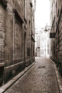 Empty alley amidst buildings in city