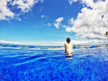 Woman swimming pool by sea