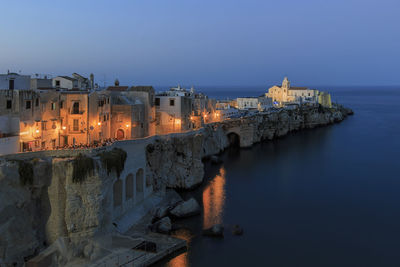 Panoramic view of illuminated buildings against sky at dusk