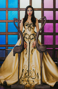 Mid adult man standing against wall