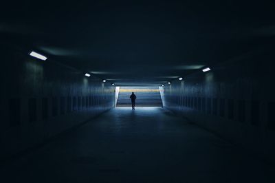 Interior of tunnel. man walking towards the light.