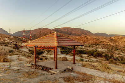 Built structure pergola on landscape against clear sky