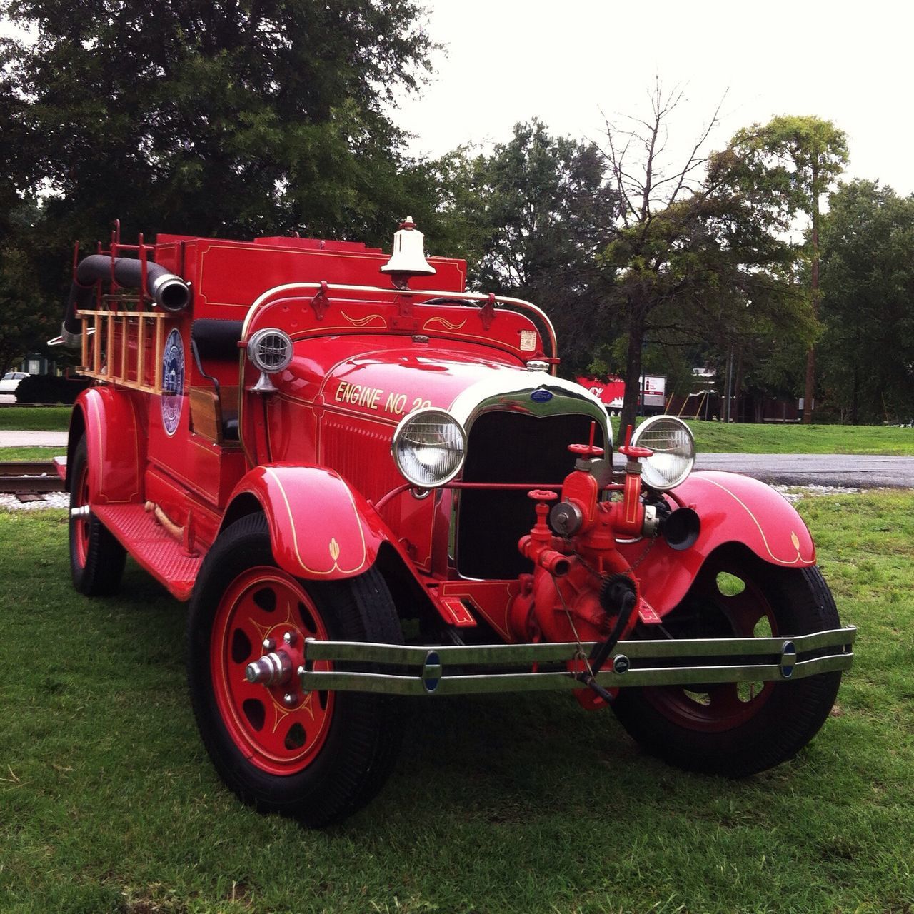 transportation, land vehicle, mode of transport, car, stationary, red, tree, vintage car, grass, travel, bicycle, motorcycle, tractor, field, parking, parked, wheel, day, vehicle, outdoors