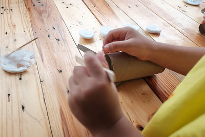 High angle view of woman hand on table