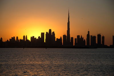 Dubai slyline from dubai creek harbour and dubai canal to downtown and business bay, uae