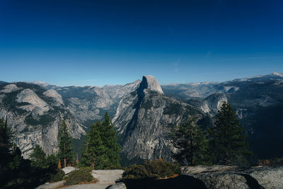 Scenic view of mountains against blue sky