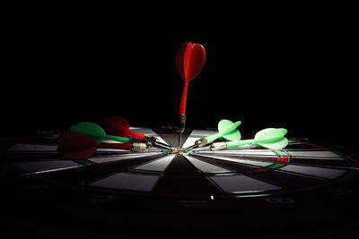 Close-up of illuminated lighting equipment against black background