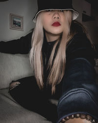 Woman wearing hat at home