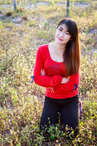 Beautiful young woman standing on land