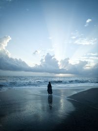 Man on beach against sky