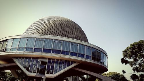 Low angle view of modern building against clear blue sky