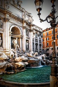 Low angle view of fountain against building