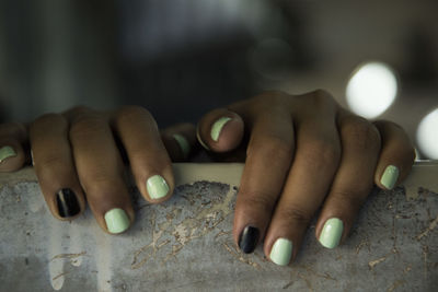 Cropped hands of woman on railing