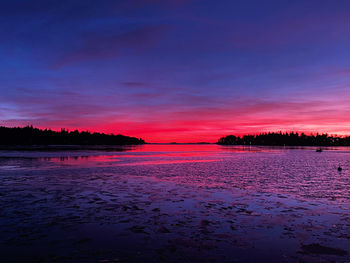 Scenic view of sea against romantic sky at sunset