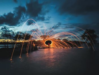 Low angle view of illuminated light trails at night