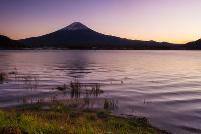 Scenic view of lake against sky during sunset