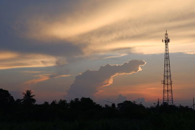 Low angle view of silhouette electricity pylon against sky during sunset