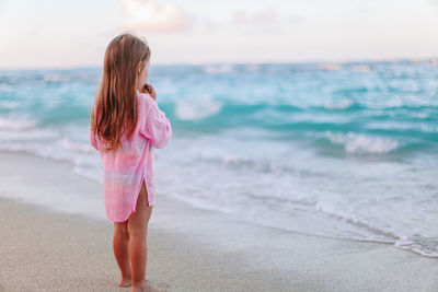 Full length of girl standing on beach