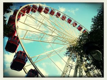 Low angle view of ferris wheel against sky