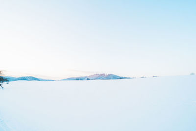 Scenic view of snowcapped mountains against clear sky