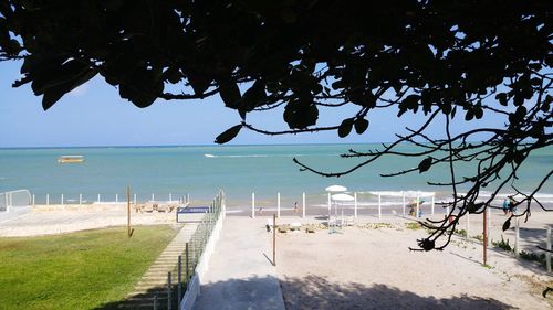 View of calm blue sea against mountain range