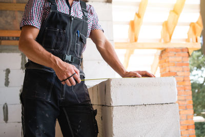 Midsection of man standing in workshop