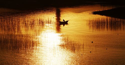 Scenic view of calm lake during sunset