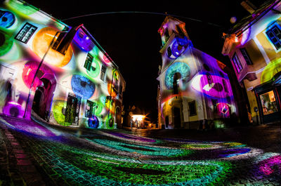 Multi colored lights on white wall