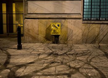 Shadow of person on floor against building