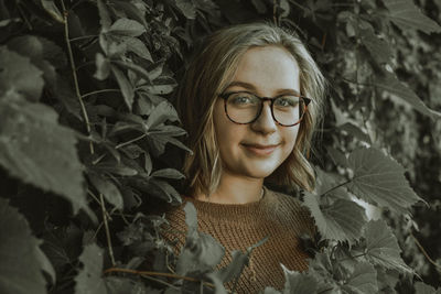 Portrait of smiling young woman with leaves