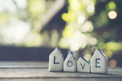 Close-up of love text on model homes at table