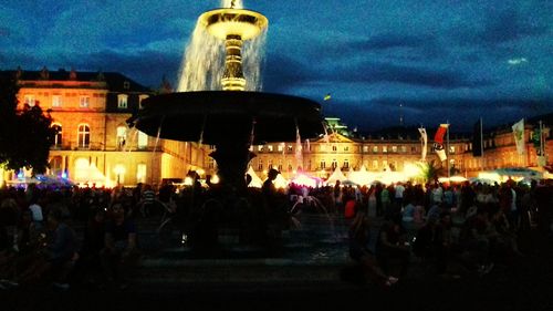 Crowd at music concert against sky at night