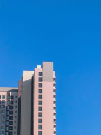 Low angle view of building against blue sky