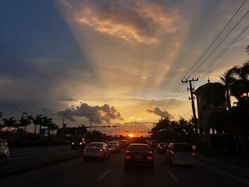 Traffic on road at sunset