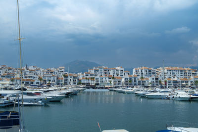 Sailboats moored in harbor