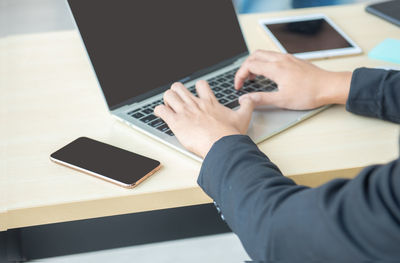 High angle view of man using laptop on table