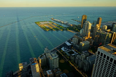 High angle view of buildings by sea against sky