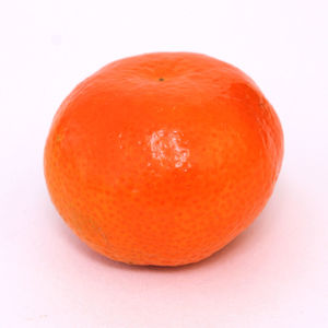 Close-up of orange apple against white background