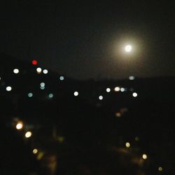 Close-up of illuminated lights against black background