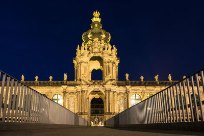 Low angle view of illuminated building against sky at night