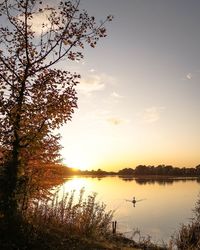 Scenic view of lake against sky at sunset