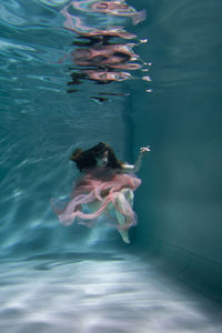 Woman swimming in swimming pool