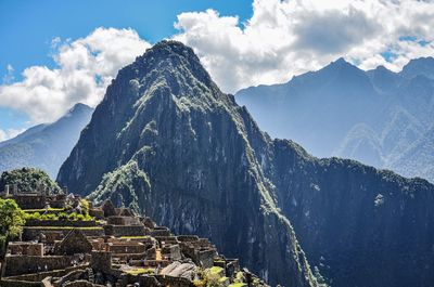 Panoramic view of ruins against cloudy sky