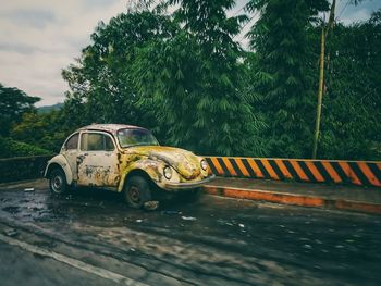 Car on road against sky during rainy season