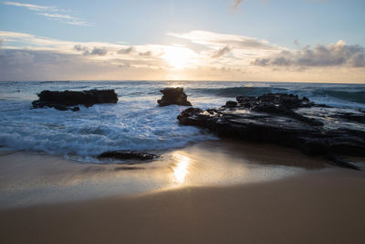 Scenic view of beach against sky during sunset