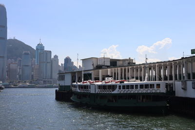 Boats in sea against buildings in the city