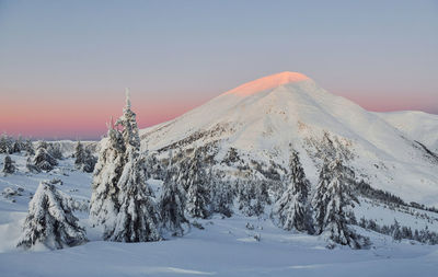 Majestic petros mountain illuminated by sunlight. magical winter landscape