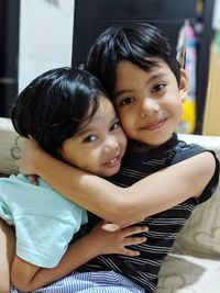 Portrait of sibling embracing