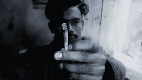 Portrait of man smoking cigarette