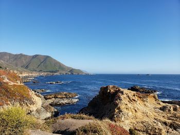 Scenic view of sea against clear blue sky